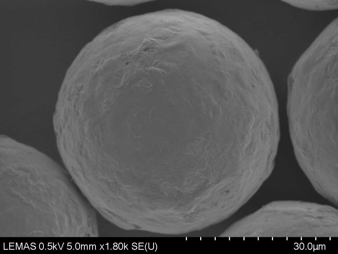 Scanning electron microscope image of typical barium titanate beads after spray coating using a water emulsion of a viscoelastic polyurethane coating.