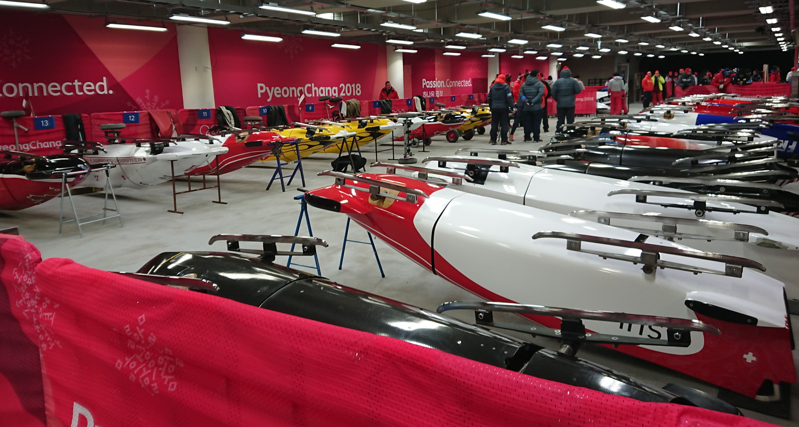 Enlarged view: "Parc fermé": Bobsleds, scrupulously material-tested and lined up waiting for the start